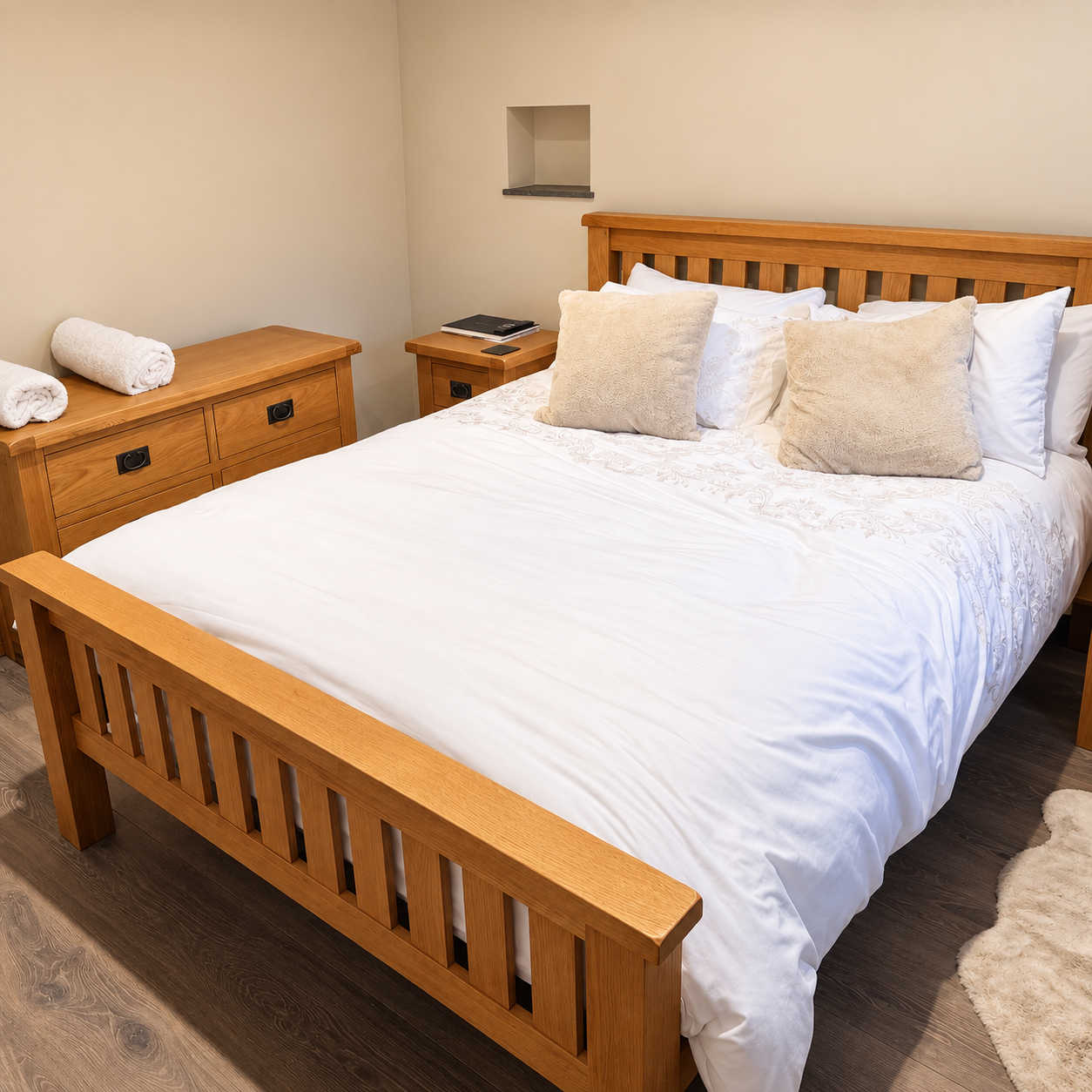 Double bedroom with oak bed and white bed linen