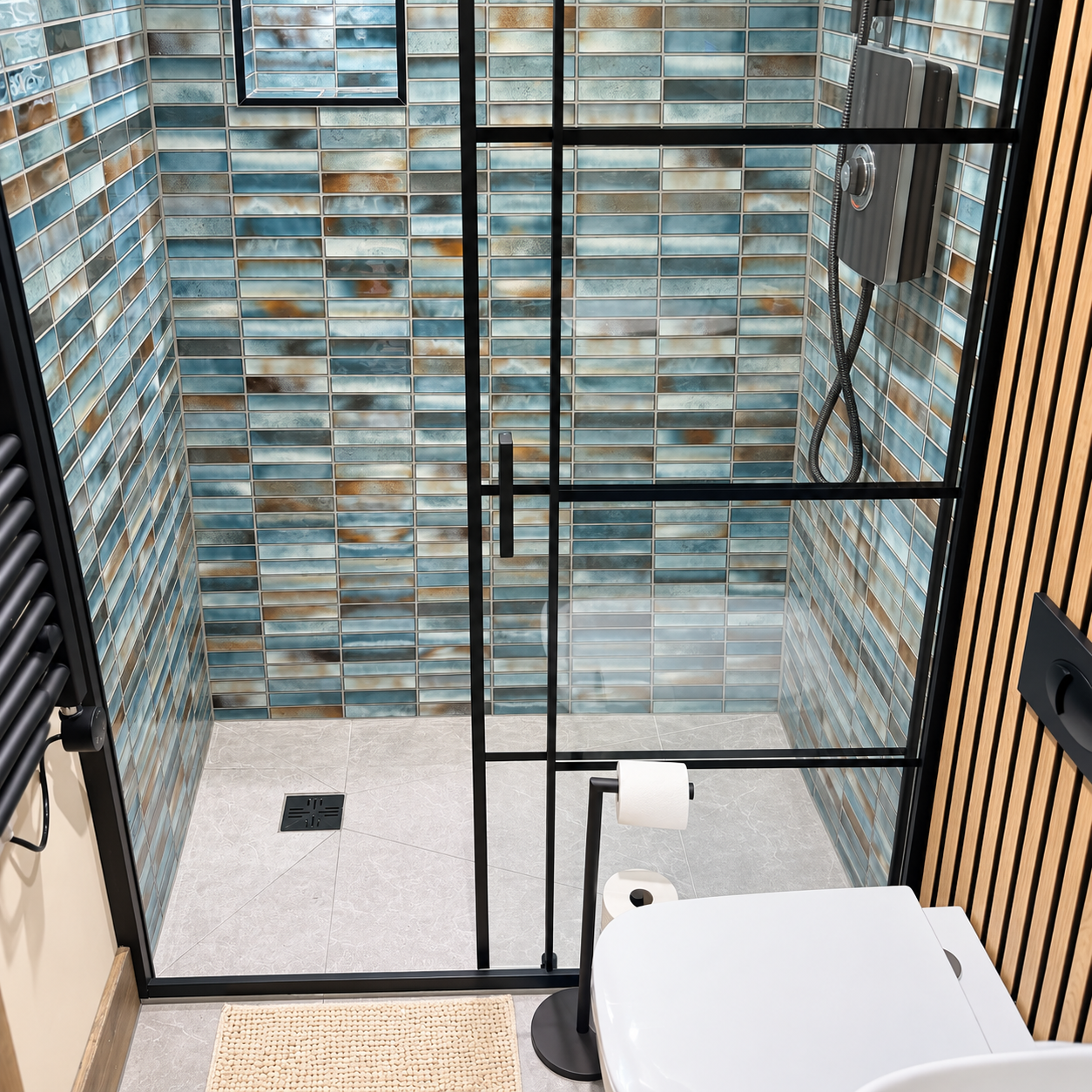 Modern shower room with blue tiles and black-framed glass